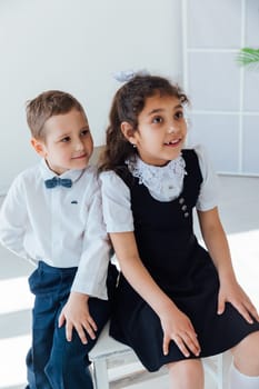 boy and girl sitting on the same chair