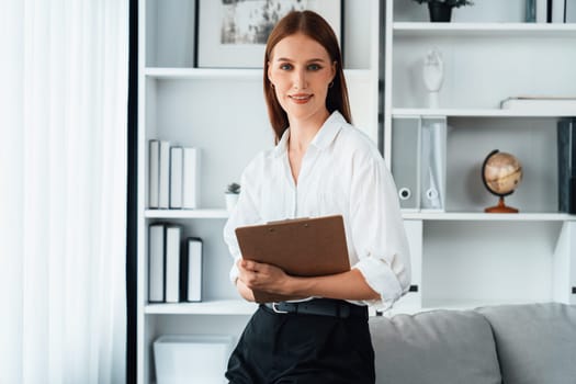 Psychologist woman in clinic office professional portrait with friendly smile feeling inviting for patient to visit the psychologist. The experienced and confident psychologist is utmost specialist