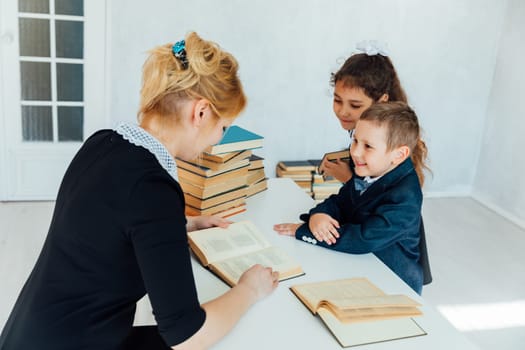 teacher teaching children in school classroom