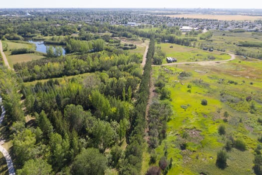 Discover the Forestry Farm Park and Zoo from above in Saskatoon. This drone image captures the park's lush landscapes, diverse wildlife, and the tranquil beauty of this cherished urban oasis.