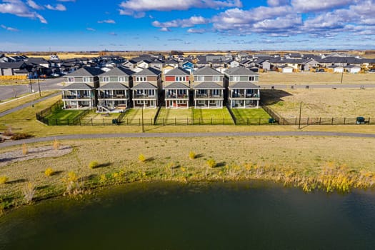Discover Kensington in Saskatoon from a bird's-eye view. This drone image highlights the neighborhood's modern architecture, green spaces, and the lively, community-focused atmosphere.