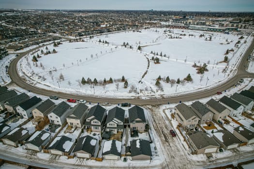 Captivating aerial shot of Stonebridge in Saskatoon, highlighting the harmonious blend of modern architecture and Saskatchewan's verdant surroundings.