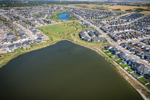 Captivating aerial shot of Stonebridge in Saskatoon, highlighting the harmonious blend of modern architecture and Saskatchewan's verdant surroundings.