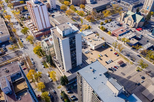 Experience the vibrant summer life of Downtown Saskatoon from above. This drone image captures the bustling streets, lush riverbanks, and lively urban atmosphere during the city's warmest months.