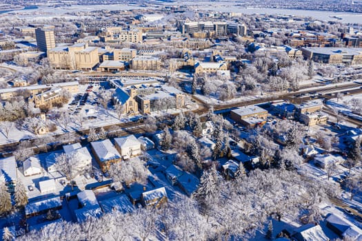 Behold the winter wonderland of Downtown Saskatoon from the sky. This drone image captures the snowy cityscape, frozen river views, and the serene beauty of urban life in the chill of winter.