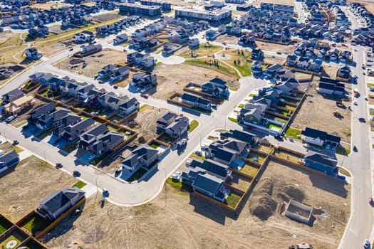 Discover Kensington in Saskatoon from a bird's-eye view. This drone image highlights the neighborhood's modern architecture, green spaces, and the lively, community-focused atmosphere.