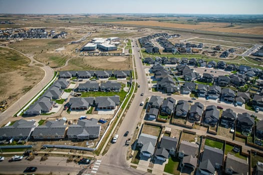 Elevated view of Rosewood neighborhood in Saskatoon, presenting a tapestry of urban design intertwined with Saskatchewan's serene natural canvas.