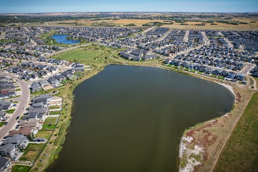 Captivating aerial shot of Stonebridge in Saskatoon, highlighting the harmonious blend of modern architecture and Saskatchewan's verdant surroundings.