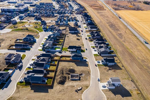Discover Kensington in Saskatoon from a bird's-eye view. This drone image highlights the neighborhood's modern architecture, green spaces, and the lively, community-focused atmosphere.