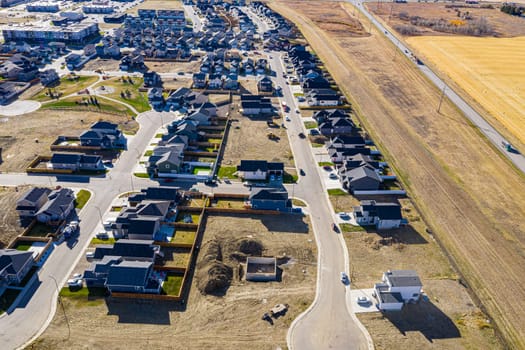Discover Kensington in Saskatoon from a bird's-eye view. This drone image highlights the neighborhood's modern architecture, green spaces, and the lively, community-focused atmosphere.