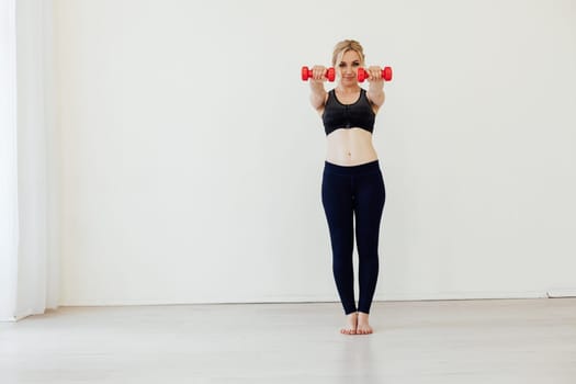 Female engaged in fitness with dumbbells sport