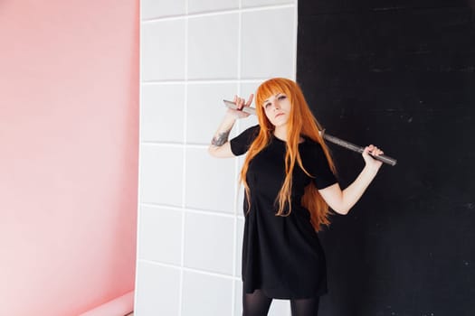 cosplayer with red hair holds Japanese sword