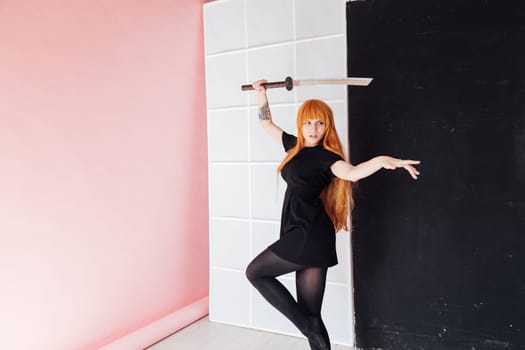 cosplayer with red hair holds Japanese sword