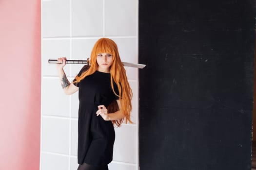 cosplayer with red hair holds Japanese sword