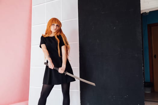 cosplayer with red hair holds Japanese sword