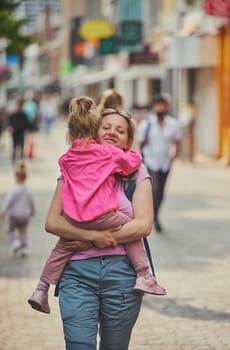 Mom and daughter walk around the city in the Netherlands.