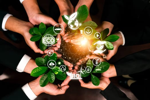 Business partnership nurturing or growing plant together with carbon icon symbolize ESG sustainable environment protection with eco technology and carbon credit solution for net zero future. Reliance