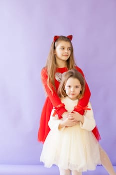 Two girls in red and white dresses