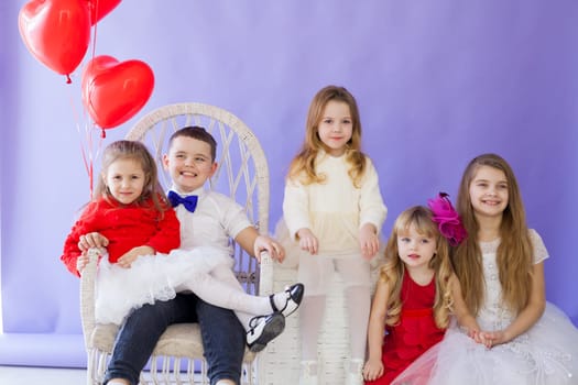 Girl's and boy sit with balloons