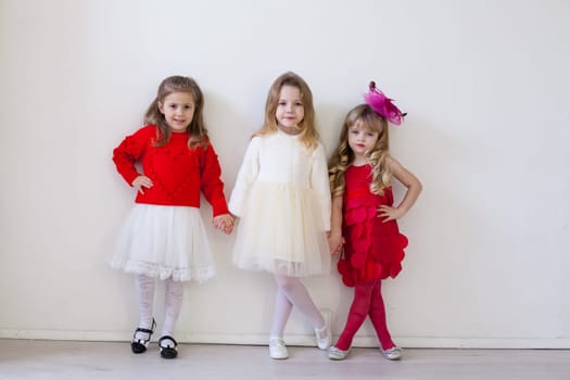 three little girl in red and white dresses