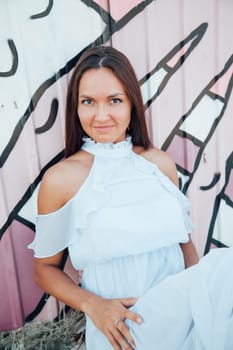 A woman with long hair sits at a multi-light wall