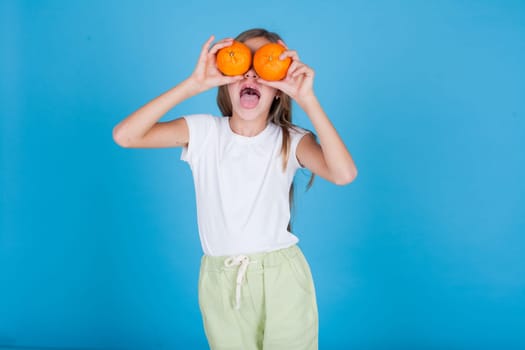Beautiful girl holding a ripe orange