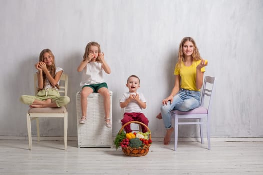 boy and girls with a basket of ripe vegetables and fruits