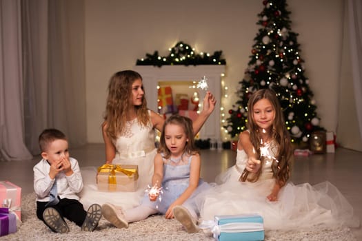 Kids boy and girls open Christmas presents new year Christmas tree