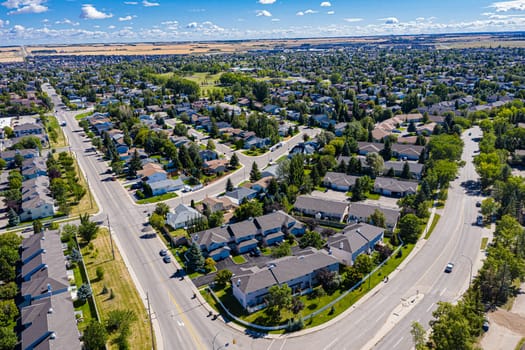 Explore the lush Forest Grove neighborhood in Saskatoon from an aerial perspective. This drone image captures the area's verdant charm, peaceful streets, and community warmth, under the vast Saskatchewan sky.