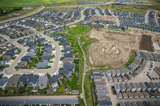 Elevated view of Rosewood neighborhood in Saskatoon, presenting a tapestry of urban design intertwined with Saskatchewan's serene natural canvas.