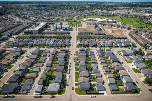 Elevated panorama of Willowgrove, showcasing the neighborhood's modern aesthetics intertwined with pockets of lush green, epitomizing Saskatoon's suburban beauty