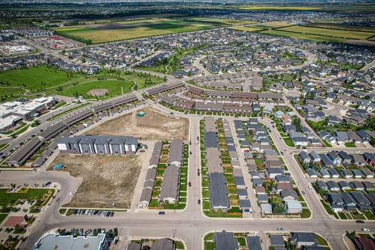 Elevated panorama of Willowgrove, showcasing the neighborhood's modern aesthetics intertwined with pockets of lush green, epitomizing Saskatoon's suburban beauty