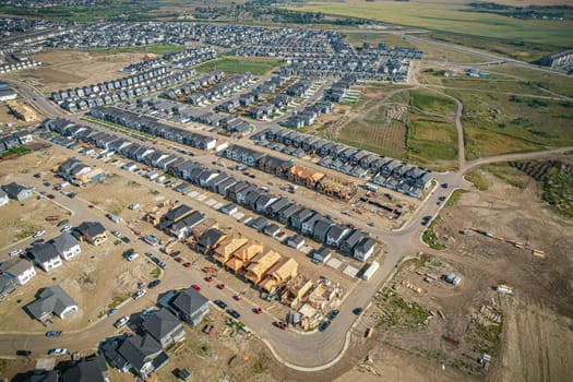 Elevated view of Rosewood neighborhood in Saskatoon, presenting a tapestry of urban design intertwined with Saskatchewan's serene natural canvas.