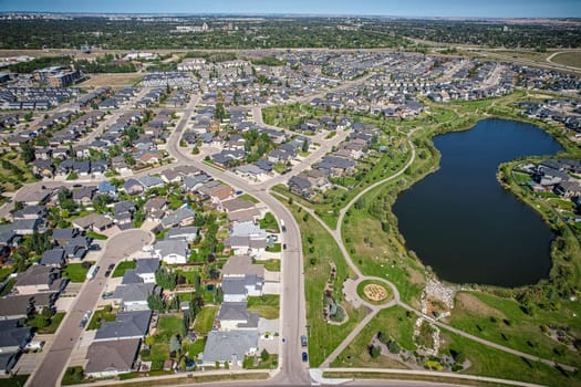 Captivating aerial shot of Stonebridge in Saskatoon, highlighting the harmonious blend of modern architecture and Saskatchewan's verdant surroundings.