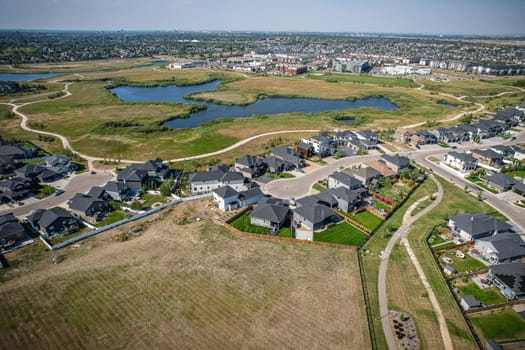 Elevated view of Rosewood neighborhood in Saskatoon, presenting a tapestry of urban design intertwined with Saskatchewan's serene natural canvas.