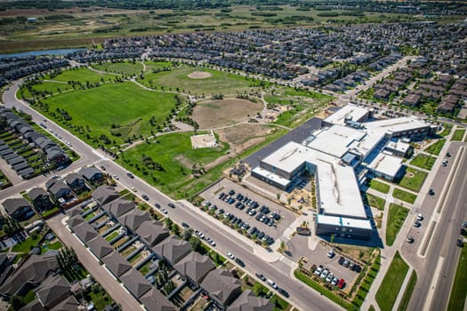 Captivating aerial shot of Stonebridge in Saskatoon, highlighting the harmonious blend of modern architecture and Saskatchewan's verdant surroundings.
