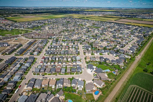 Elevated panorama of Willowgrove, showcasing the neighborhood's modern aesthetics intertwined with pockets of lush green, epitomizing Saskatoon's suburban beauty