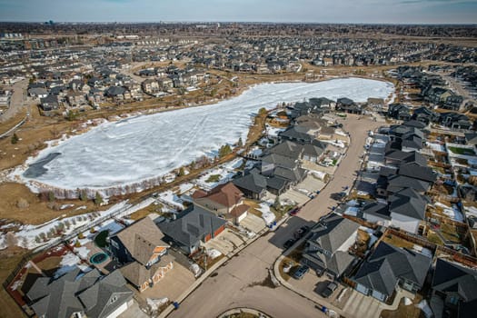 Captivating aerial shot of Stonebridge in Saskatoon, highlighting the harmonious blend of modern architecture and Saskatchewan's verdant surroundings.