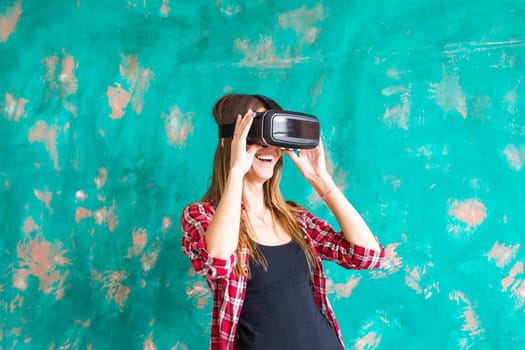 Young woman with pleasure uses head-mounted display.