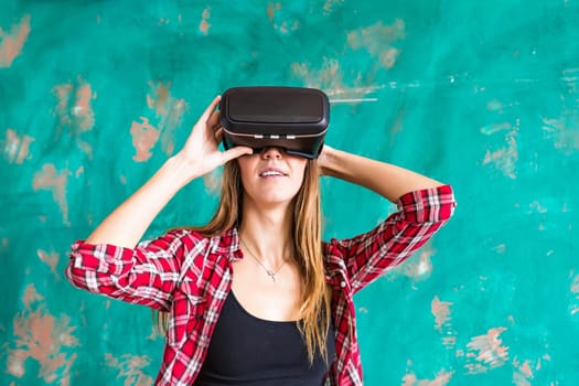 Young woman with pleasure uses head-mounted display.