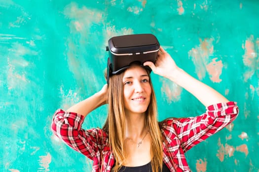 Young woman with pleasure uses head-mounted display.