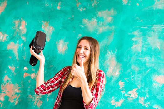 Young woman with pleasure uses head-mounted display.