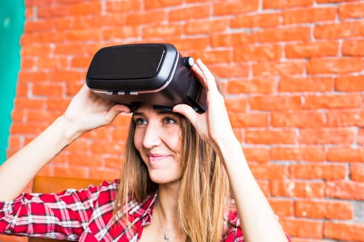 Young woman with pleasure uses head-mounted display.