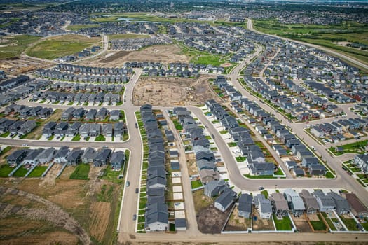 Elevated view of Rosewood neighborhood in Saskatoon, presenting a tapestry of urban design intertwined with Saskatchewan's serene natural canvas.