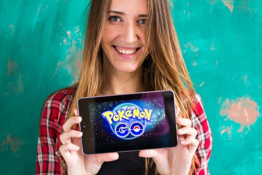 Ufa, Russia. - July 29: Woman show the tablet with Pokemon Go logo