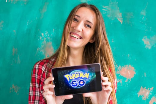 Ufa, Russia. - July 29: Woman show the tablet with Pokemon Go logo