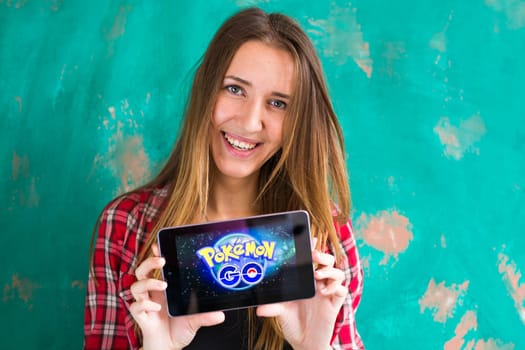 Ufa, Russia. - July 29: Woman show the tablet with Pokemon Go logo