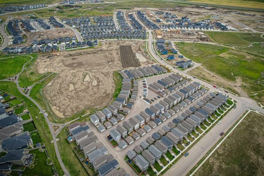 Elevated view of Rosewood neighborhood in Saskatoon, presenting a tapestry of urban design intertwined with Saskatchewan's serene natural canvas.