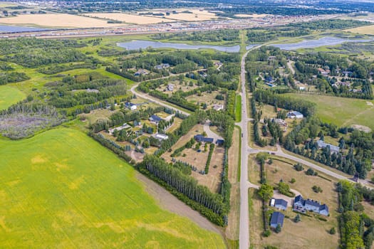 Experience the charm of Cedar Villa Estates from above. This drone image beautifully showcases the area's spacious estates, lush greenery, and tranquil setting, offering a unique aerial perspective of Saskatoon.
