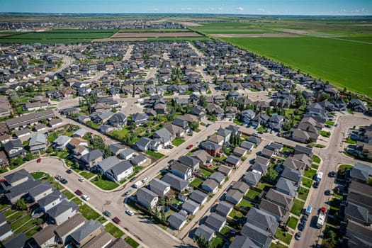 Elevated panorama of Willowgrove, showcasing the neighborhood's modern aesthetics intertwined with pockets of lush green, epitomizing Saskatoon's suburban beauty